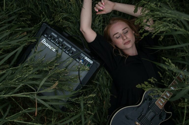 Girl With Amp and Guitar on Grass